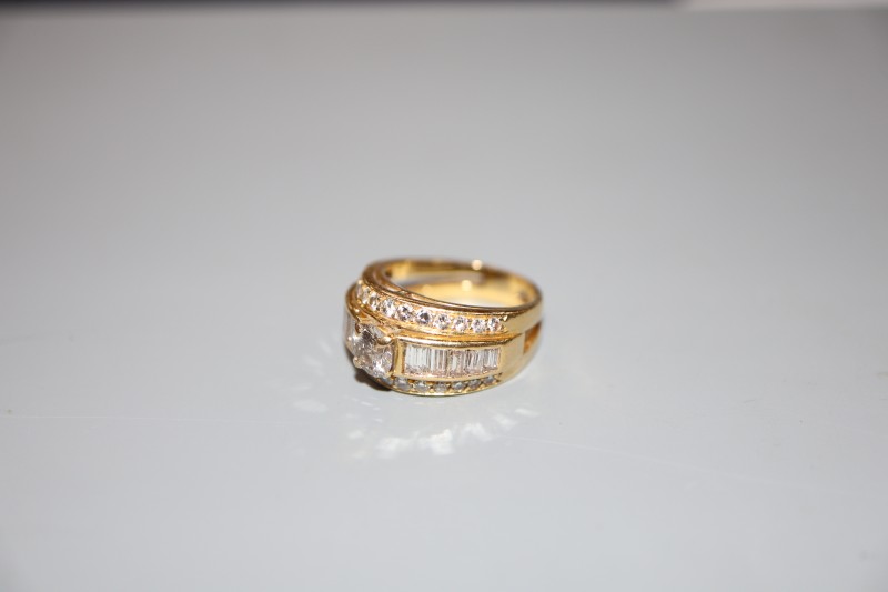 A modern yellow metal and three row diamond set dress ring, size J, gross 7 grams, set with round and baguette cut stones.